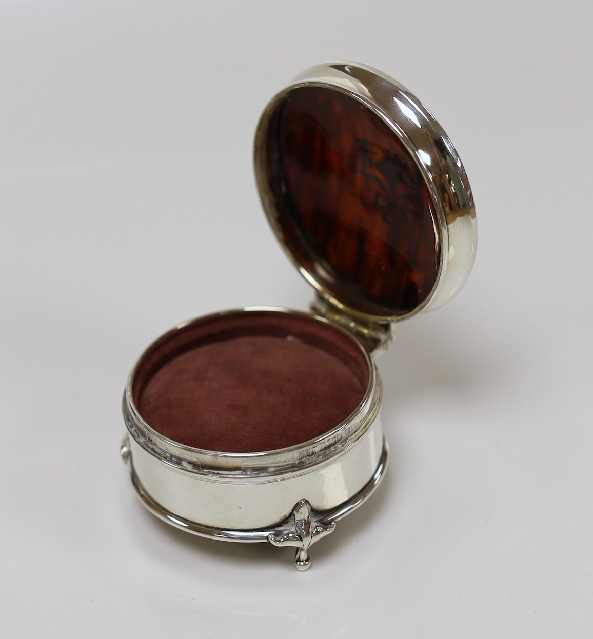 A George V silver and tortoiseshell pique mounted circular trinket box, Robert Pringle & Sons, London, 1922, 62mm.